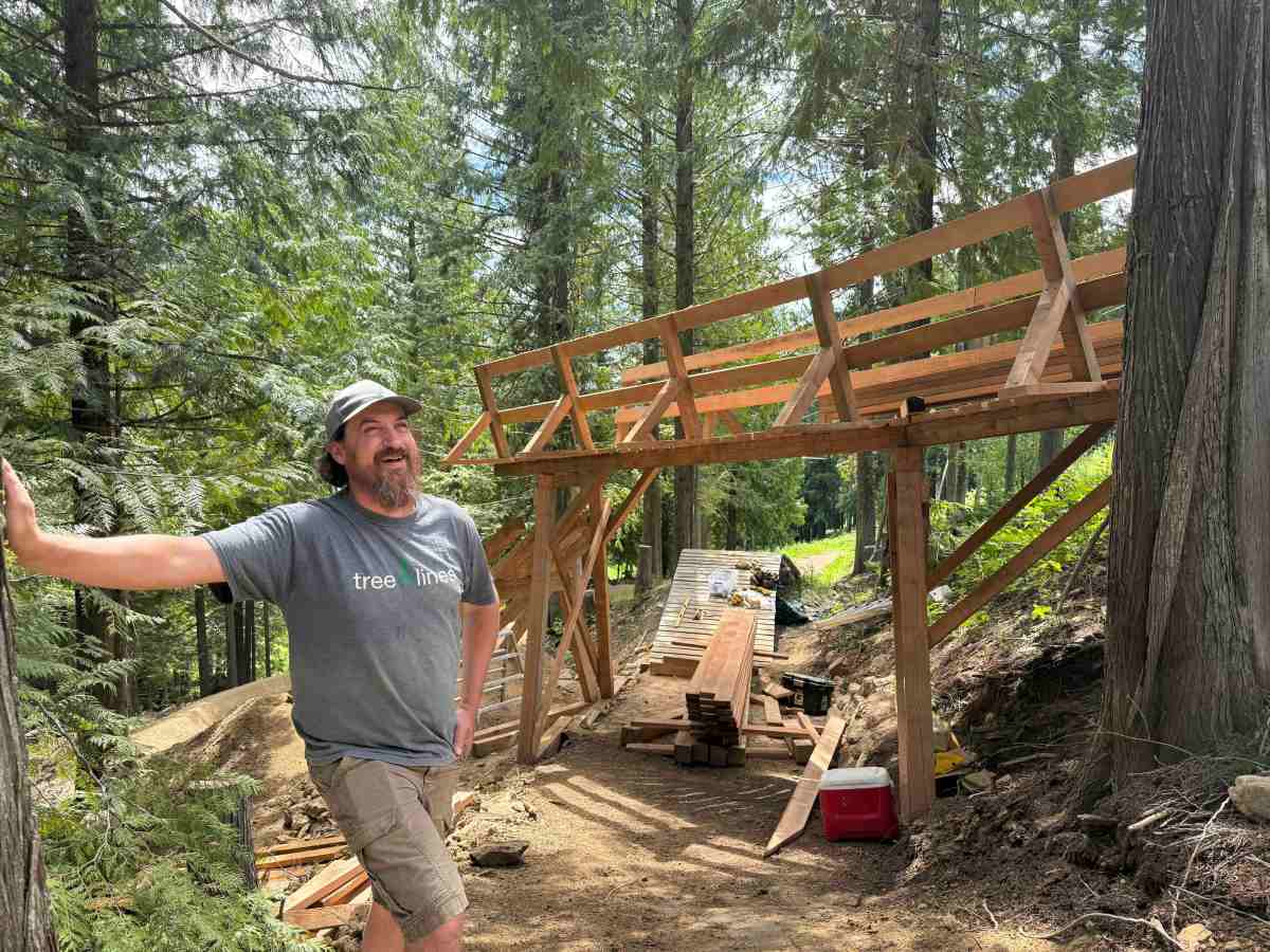 Freeride trail builder and wood craftsman Dave Satanove standing at the entrance of Obsidius at RED Bike Park; photo/Morgan Tilton
