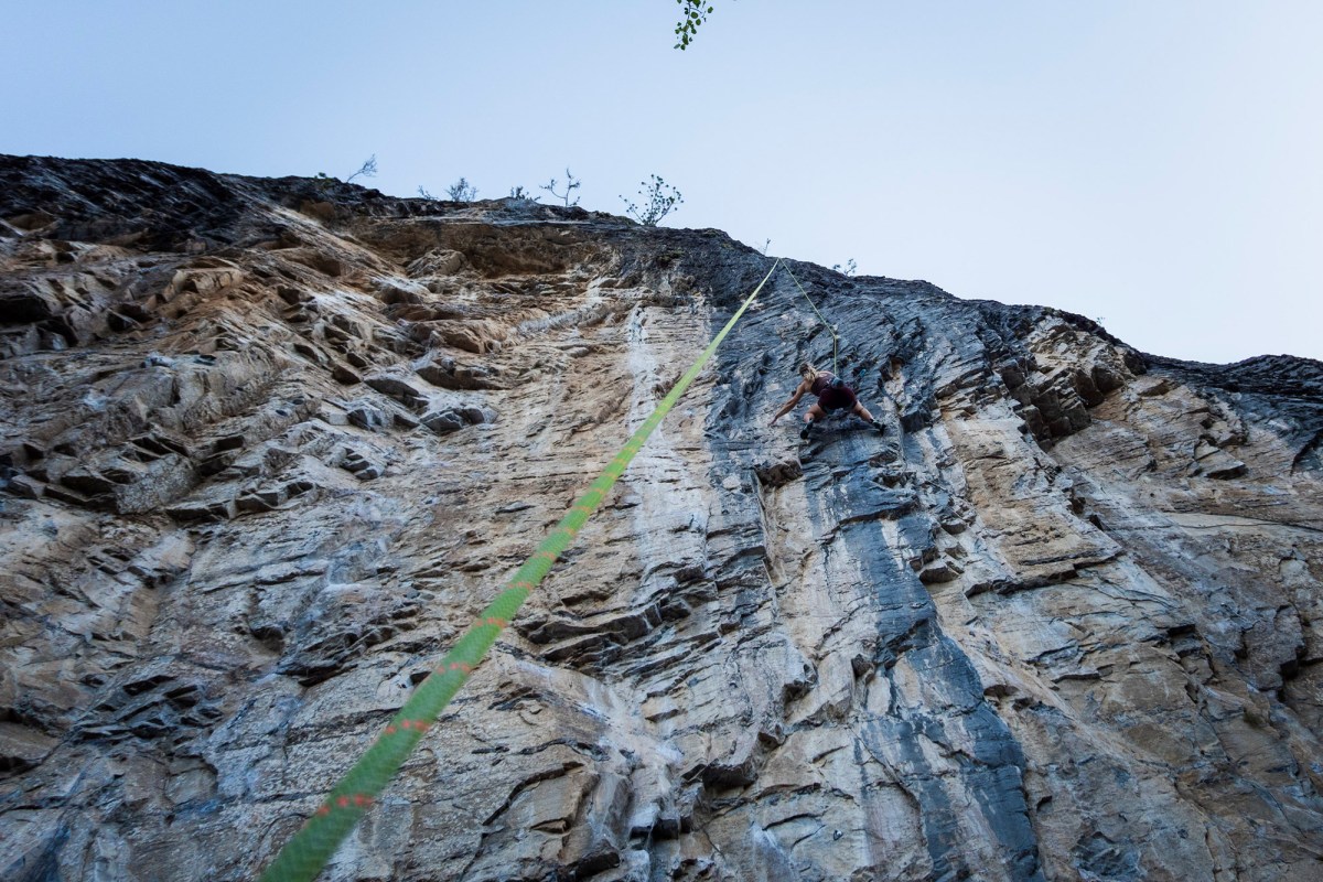 Climber ascending a steep rock face with a Mammut 9.8mm dry rope