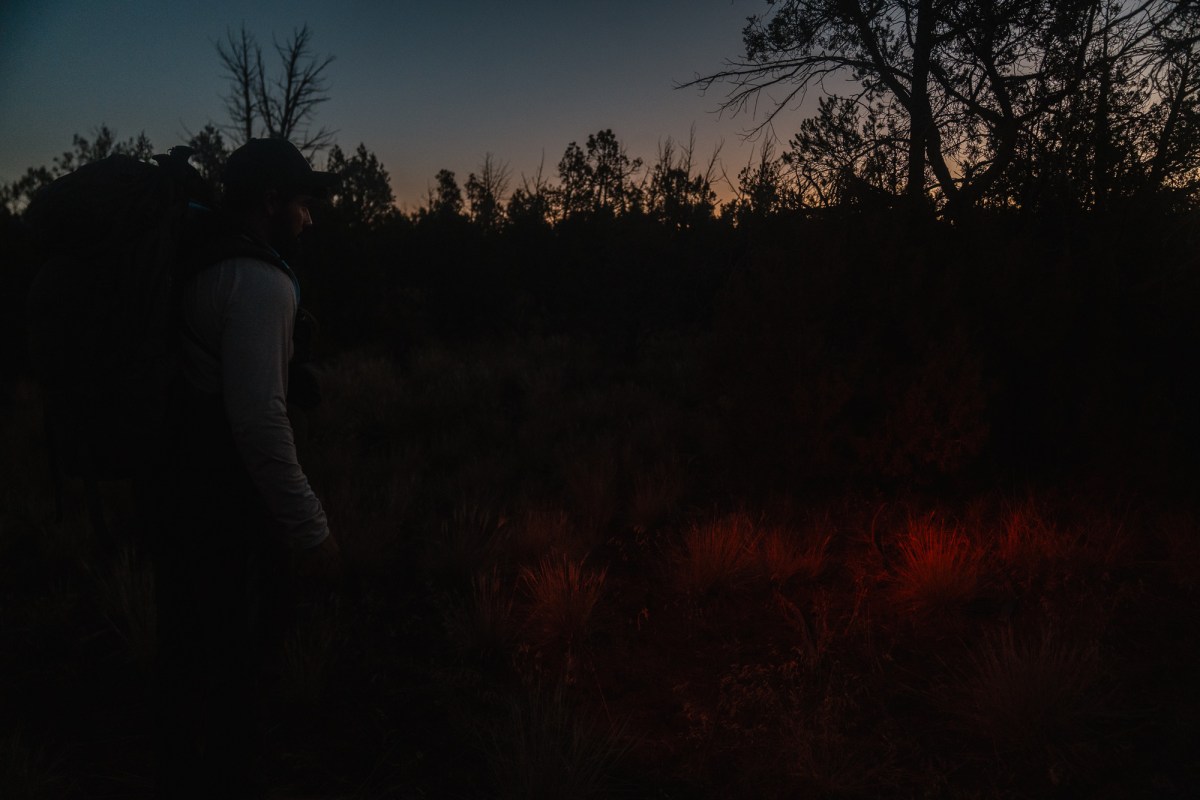 a man in the dark with Dark Energy Oracle Headlamp
