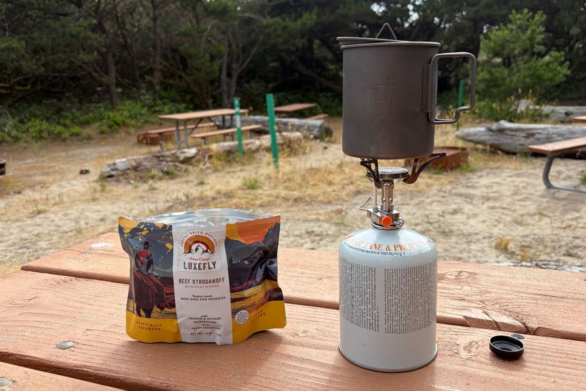 gsi glacier canister-top stove hooked up to fuel next to dehydrated meal during testing