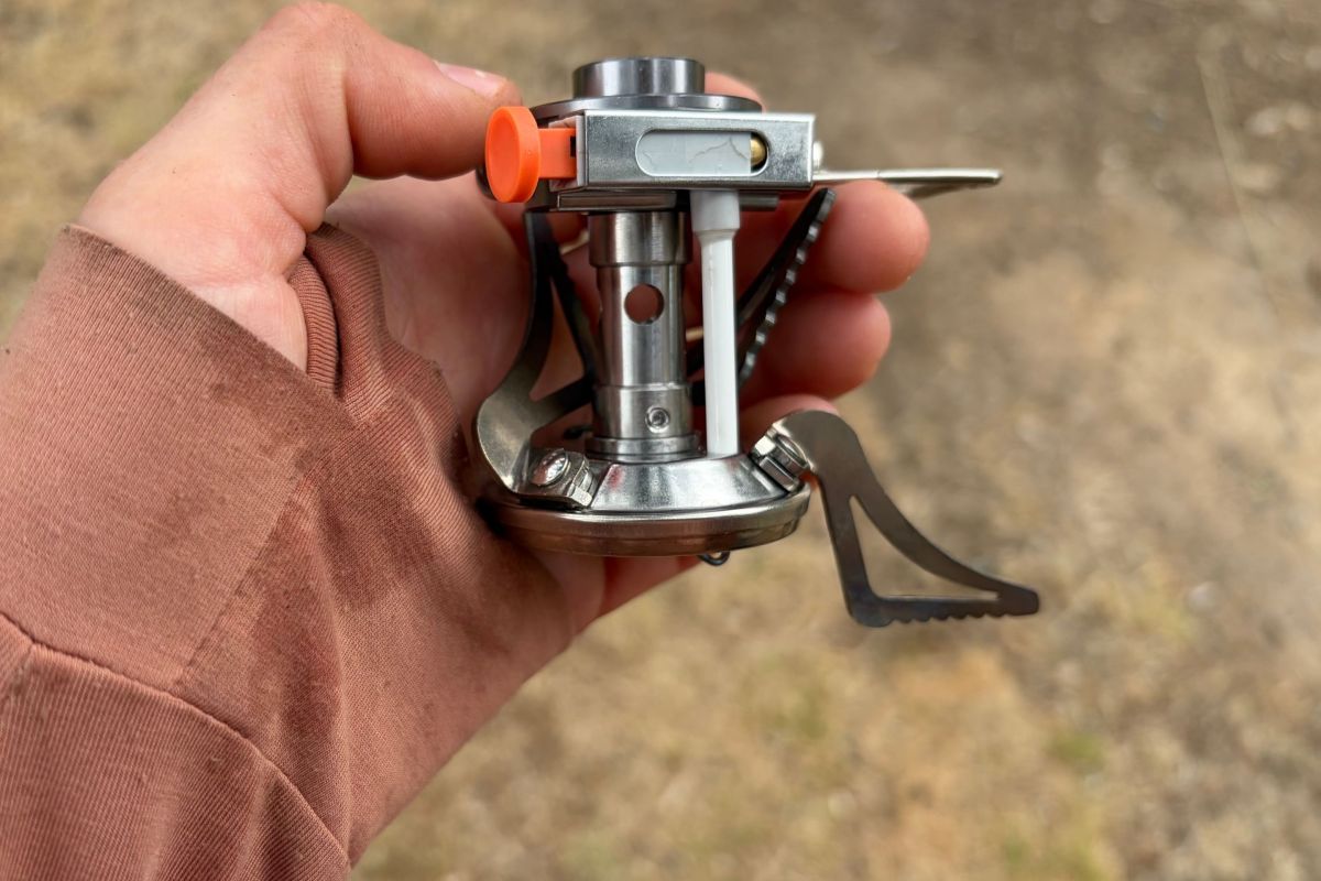 close up shot of gsi glacier canister-top stove in the hand of the reviewer during gearjunkie testing