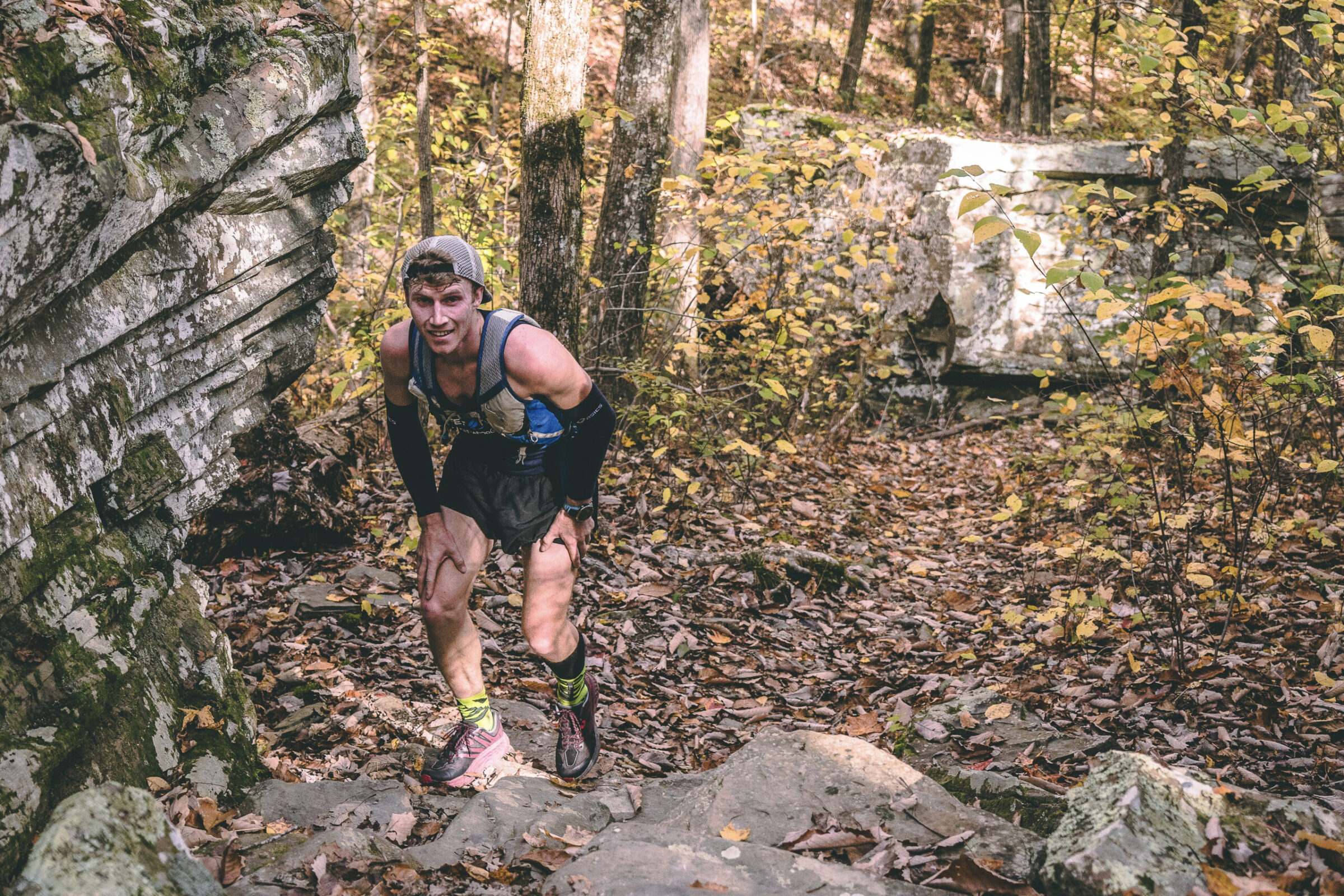 Man trail running through a forested trail 