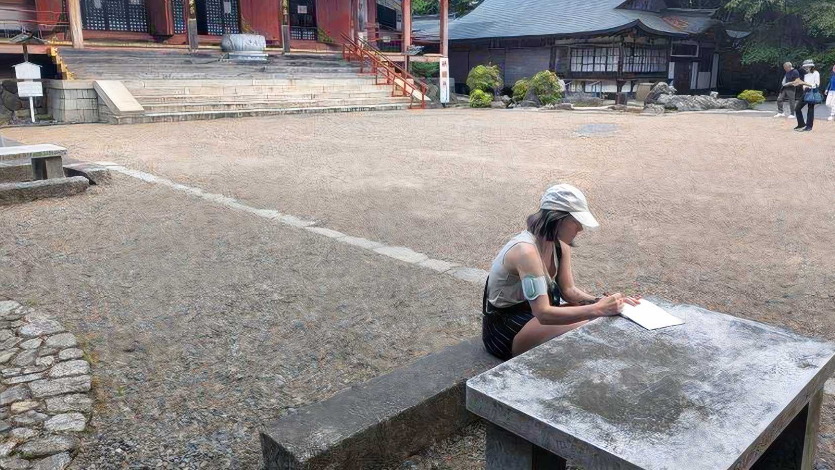 TJ takes a break on the grounds of a temple in Japan while wearing Nerivio, a prescription neuromodulation device she uses to help manage migraine symptoms while traveling. (Courtesy of TJ)
