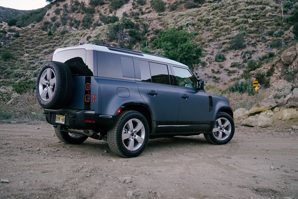 2026 Land Rover Defender 110 rear three quarter view on dirt