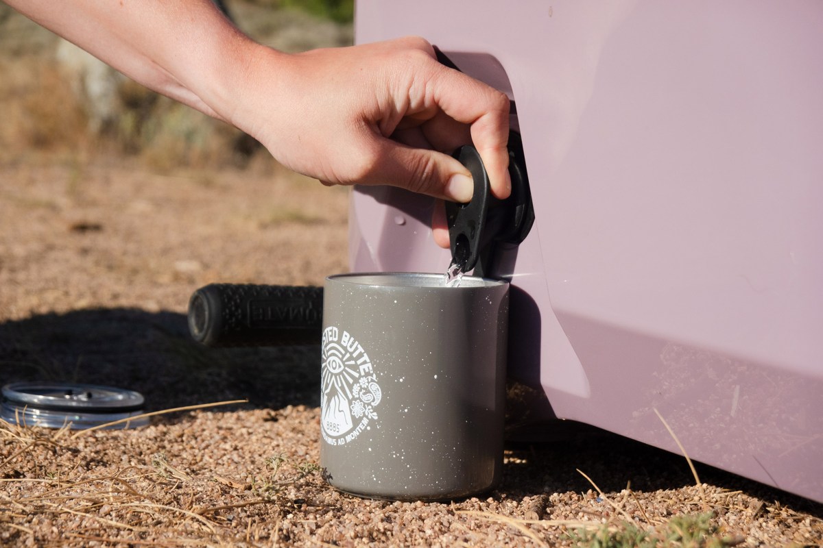 Filling a cup from the BrüTank cooler drink tap