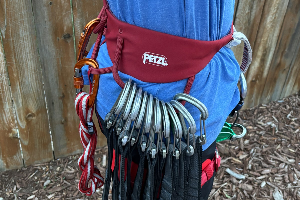 Petzl climbing harness carrying cams, carabiners, and slings