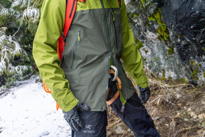 a gearjunkie tester displays the double zipper clearance for a climbing harness belay loop