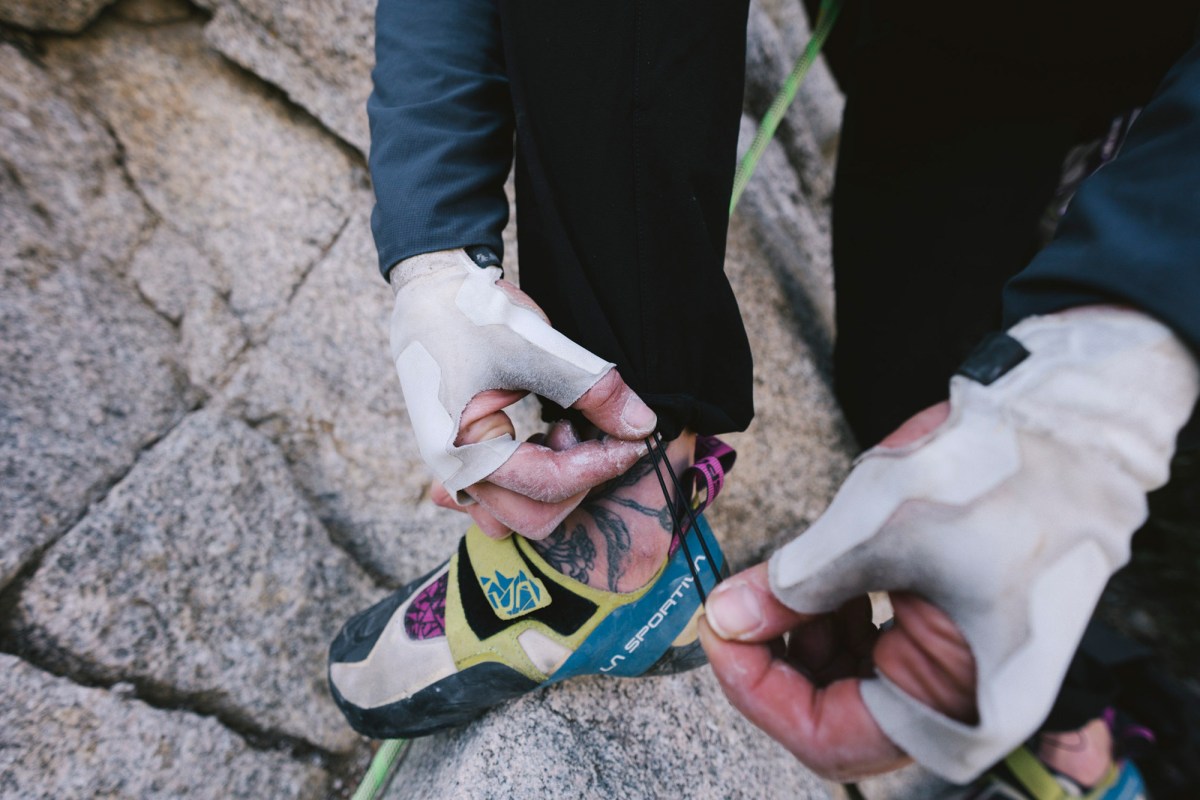 Drawcord ankle adjustment on The North Face climbing pants above a climbing shoe