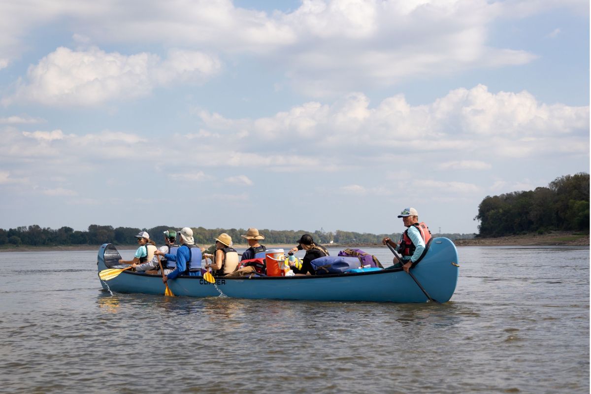 people on canoe in river