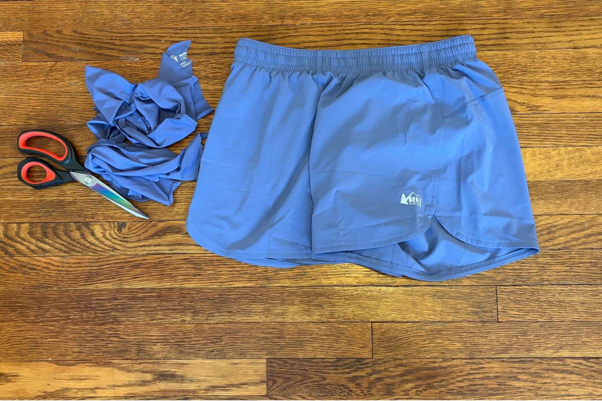 pair of shorts on ground with scissors