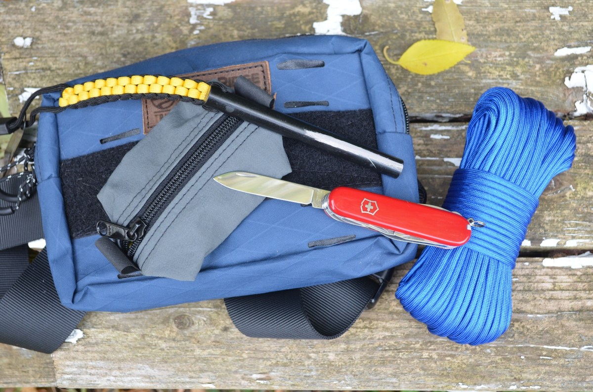 Victorinox Huntsman knife beside paracord and outdoor gear