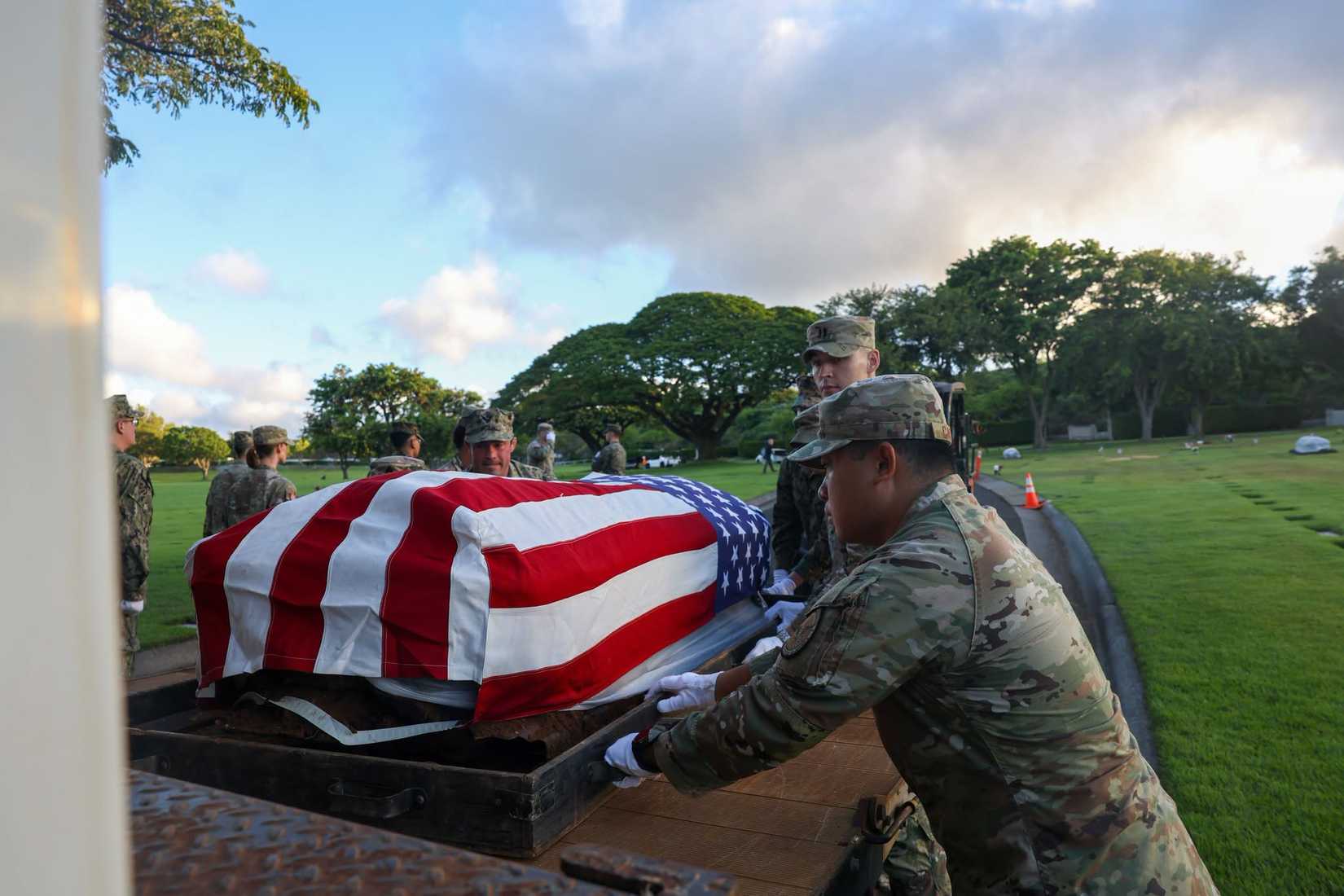 Personnel and participating service members of the Defense POW/MIA Accounting Agency at a disinterment ceremony at the National Memorial Cemetery of the Pacific in Honolulu, Hawaii. (DPAA).