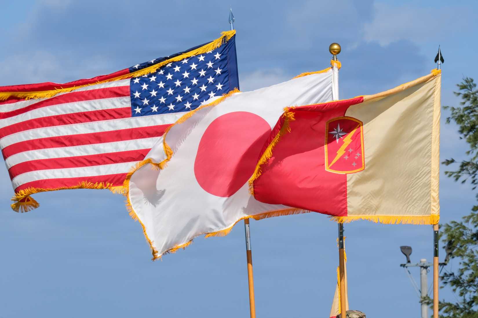 American flag, Japanese flag and 45th Sustainment Brigade colors. (DVIDS).