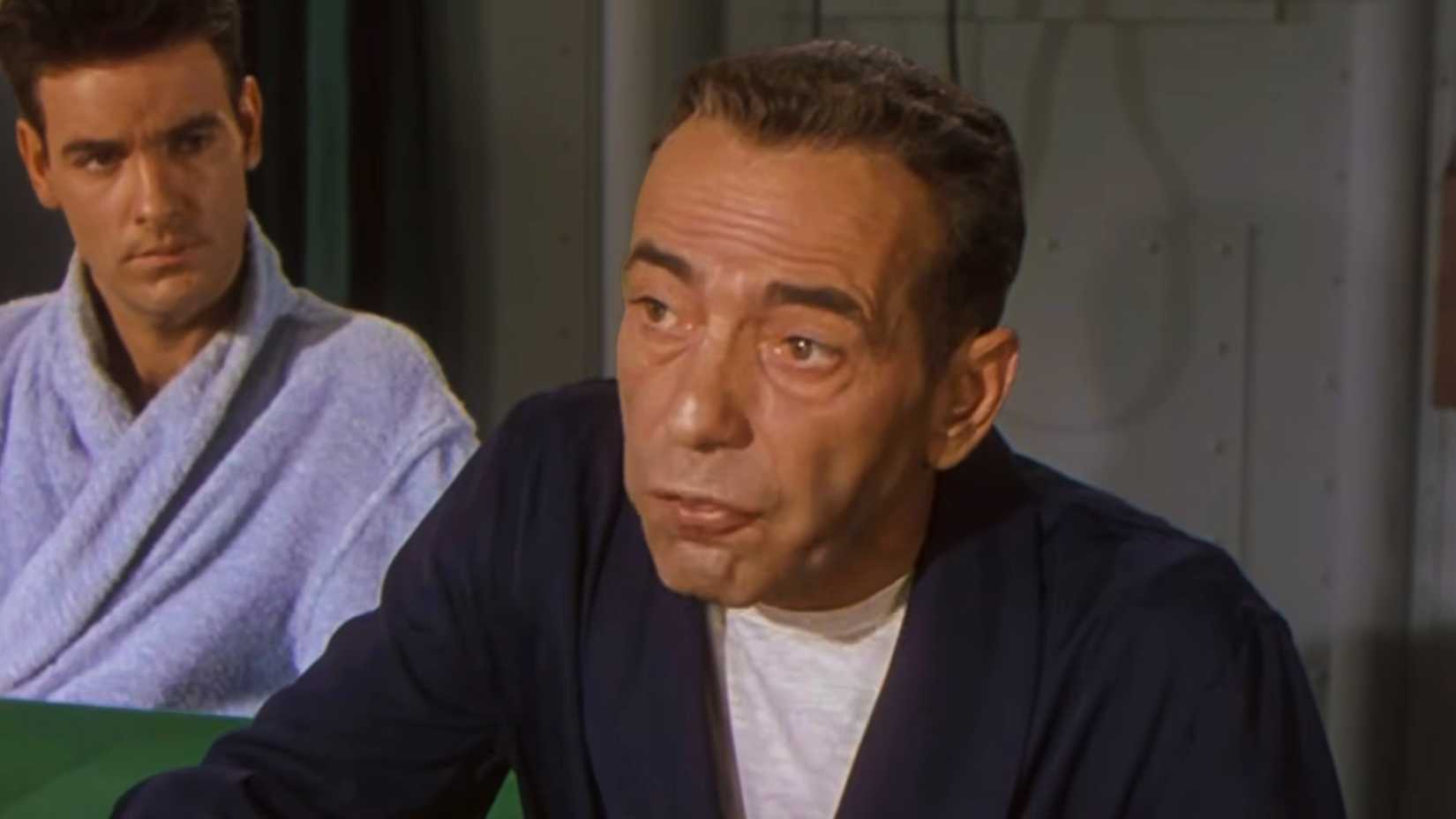 Humphrey Bogart as Lt. Cmdr. Philip Francis Queeg seated aboard a Navy ship in the 1954 film The Caine Mutiny.