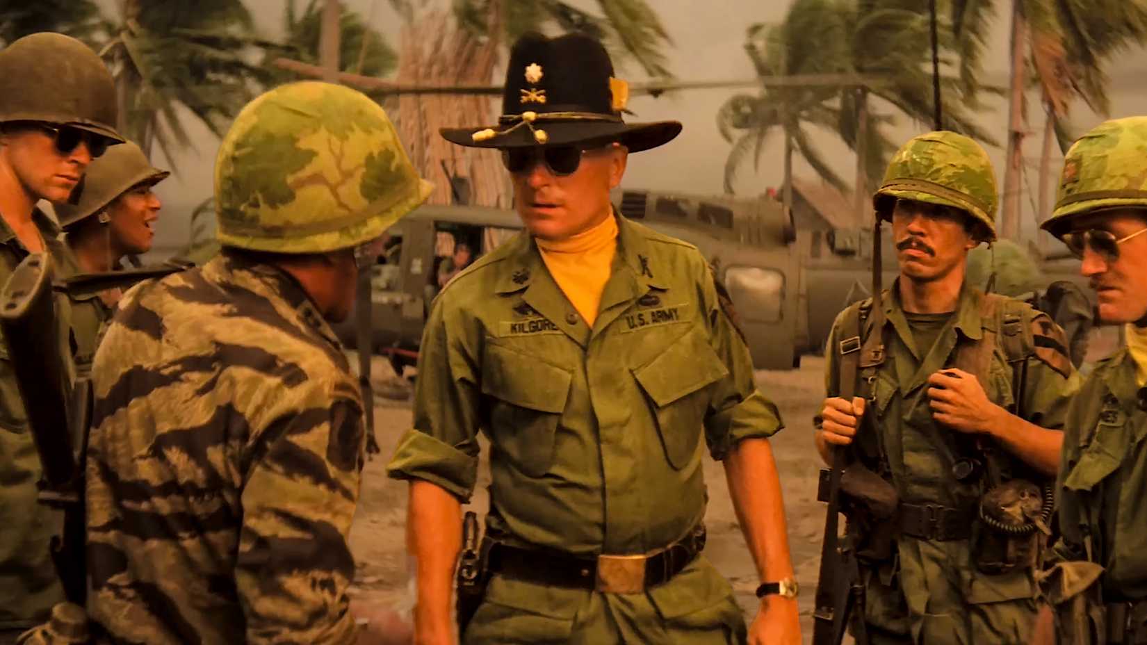 Robert Duvall as Lt. Col. Bill Kilgore standing among US Army soldiers in Vietnam War uniforms in Apocalypse Now.